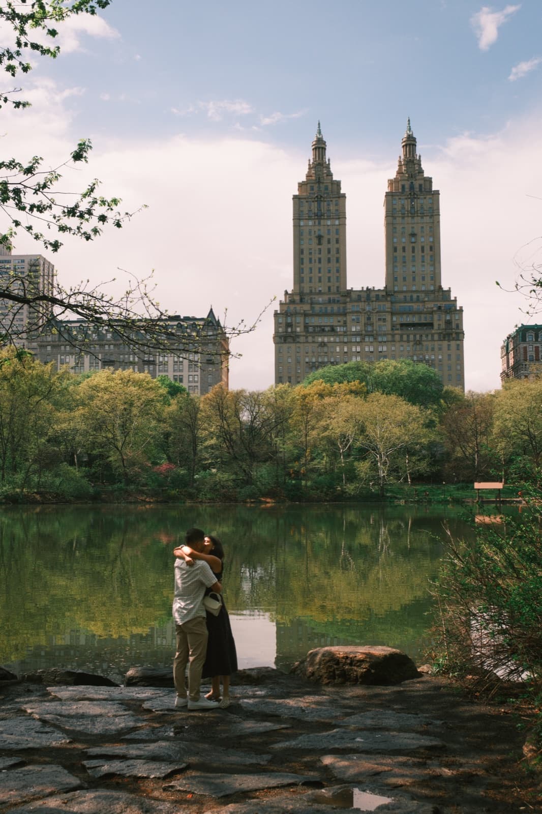 A couple embracing by the lake in Central Park, shot on film